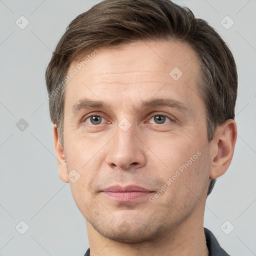 Joyful white adult male with short  brown hair and grey eyes