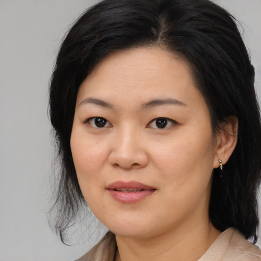 Joyful asian young-adult female with medium  black hair and brown eyes