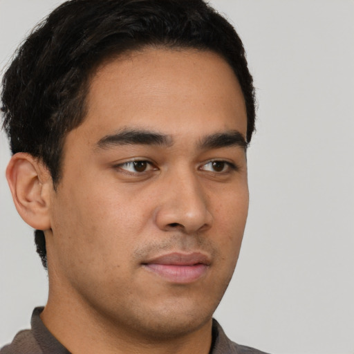 Neutral latino young-adult male with short  brown hair and brown eyes