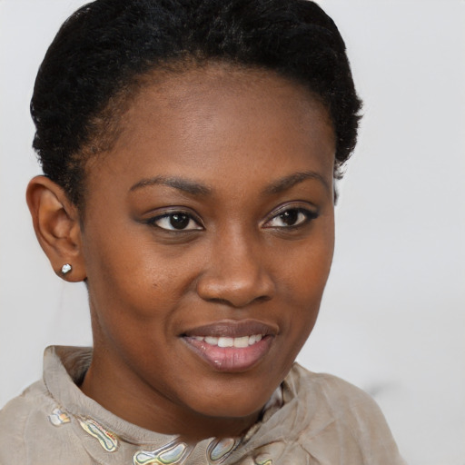 Joyful black young-adult female with short  brown hair and brown eyes