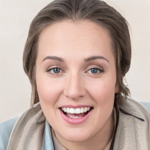 Joyful white young-adult female with medium  brown hair and grey eyes