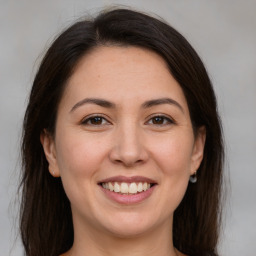 Joyful white young-adult female with medium  brown hair and brown eyes