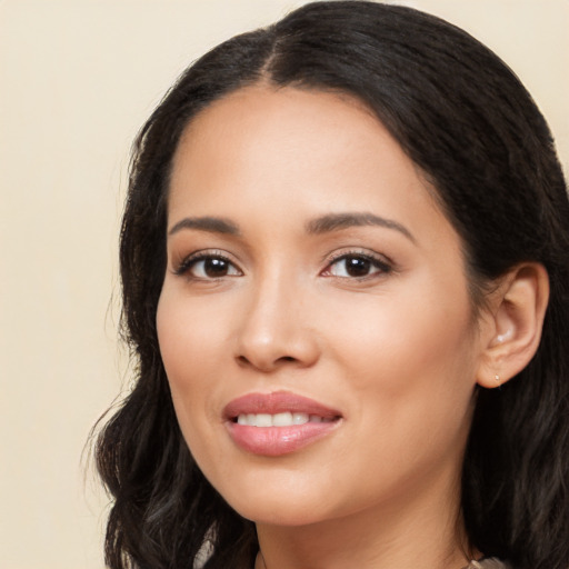 Joyful latino young-adult female with long  black hair and brown eyes