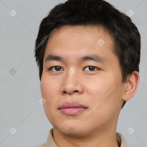 Joyful asian young-adult male with short  brown hair and brown eyes