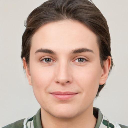 Joyful white young-adult female with short  brown hair and grey eyes