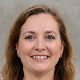 Joyful white adult female with long  brown hair and grey eyes