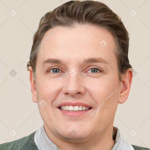 Joyful white adult male with short  brown hair and grey eyes