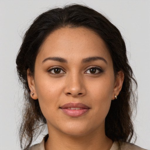 Joyful latino young-adult female with long  brown hair and brown eyes