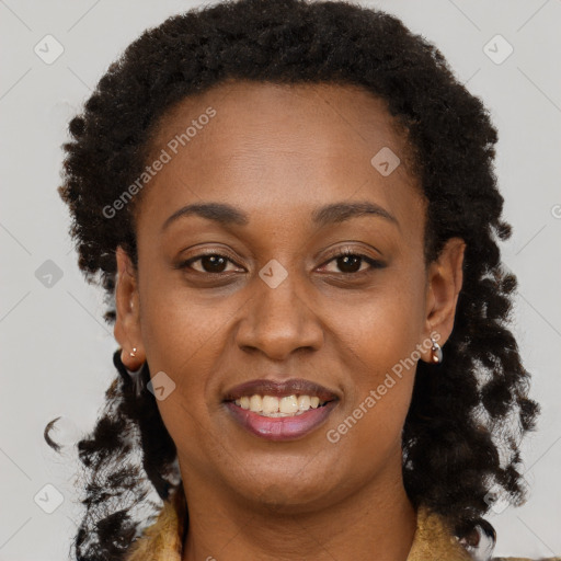 Joyful black adult female with long  brown hair and brown eyes