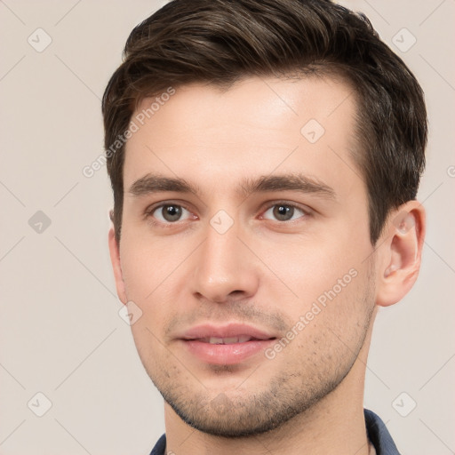 Joyful white young-adult male with short  brown hair and brown eyes