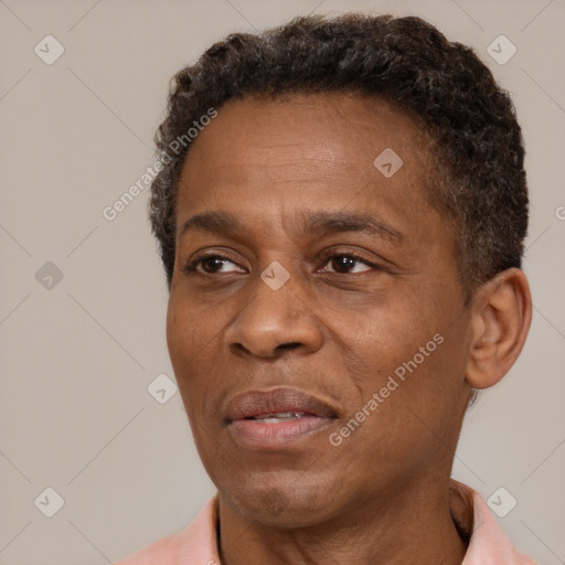 Joyful latino adult male with short  brown hair and brown eyes