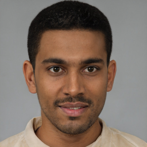 Joyful latino young-adult male with short  brown hair and brown eyes