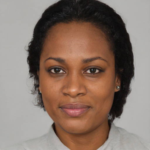 Joyful latino adult female with medium  black hair and brown eyes