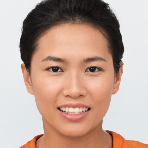 Joyful asian young-adult female with short  brown hair and brown eyes