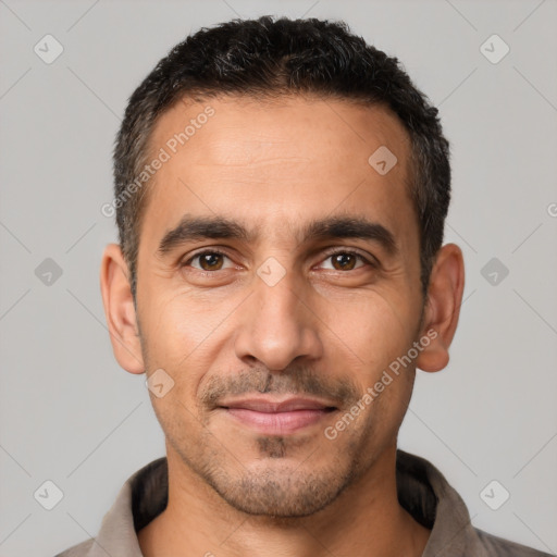 Joyful white adult male with short  black hair and brown eyes