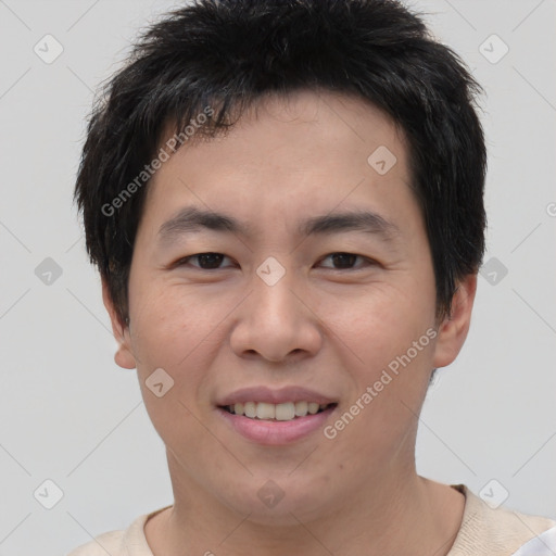 Joyful asian young-adult male with short  brown hair and brown eyes