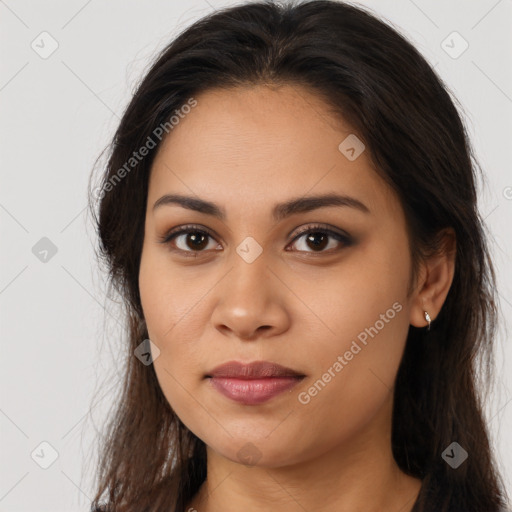 Joyful latino young-adult female with long  brown hair and brown eyes