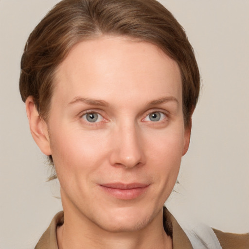 Joyful white young-adult female with short  brown hair and grey eyes