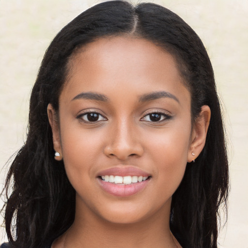 Joyful latino young-adult female with long  black hair and brown eyes