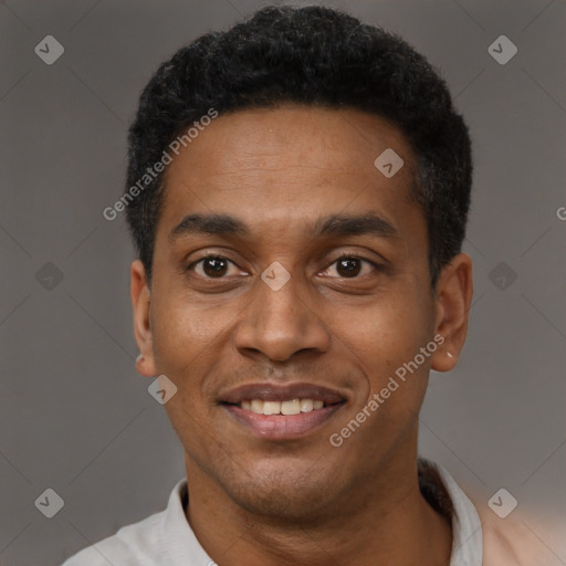 Joyful black young-adult male with short  black hair and brown eyes