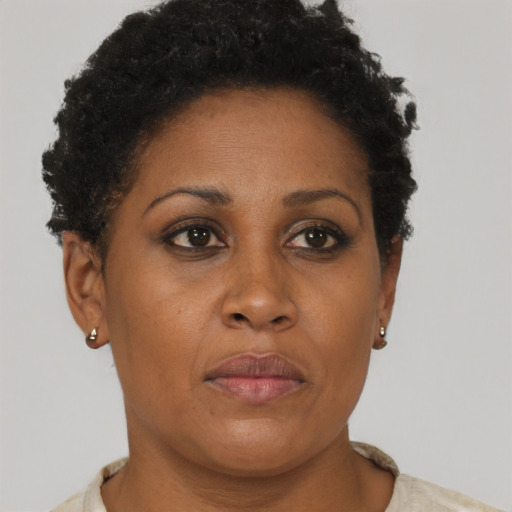 Joyful black adult female with short  brown hair and brown eyes