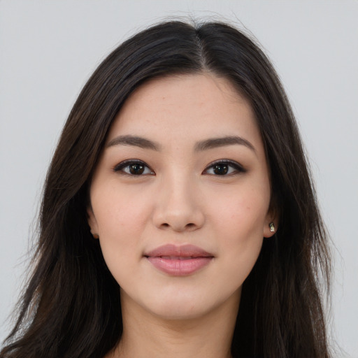 Joyful asian young-adult female with long  brown hair and brown eyes