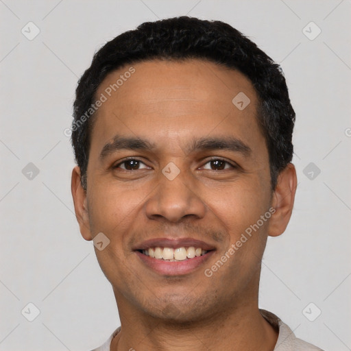 Joyful latino young-adult male with short  black hair and brown eyes