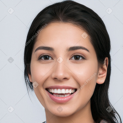 Joyful white young-adult female with long  black hair and brown eyes