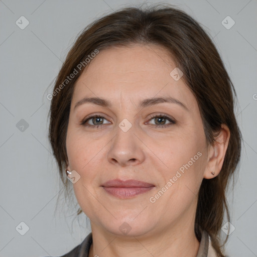 Joyful white adult female with medium  brown hair and brown eyes