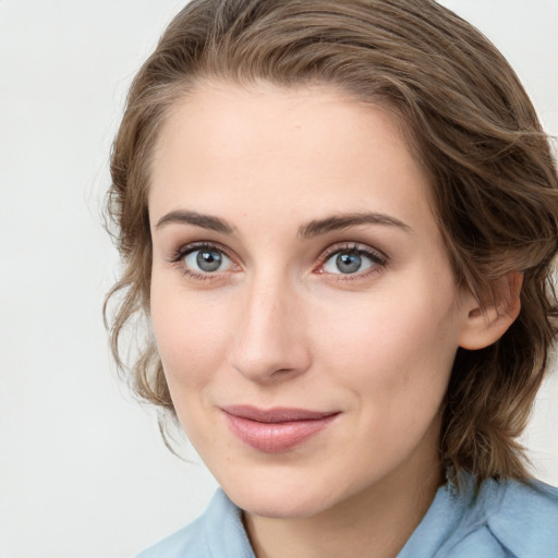 Joyful white young-adult female with medium  brown hair and blue eyes