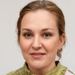 Joyful white adult female with medium  brown hair and grey eyes