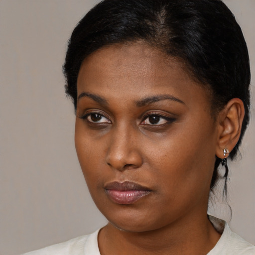 Neutral black young-adult female with medium  brown hair and brown eyes