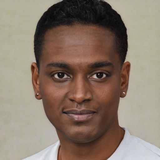 Joyful black young-adult male with short  black hair and brown eyes