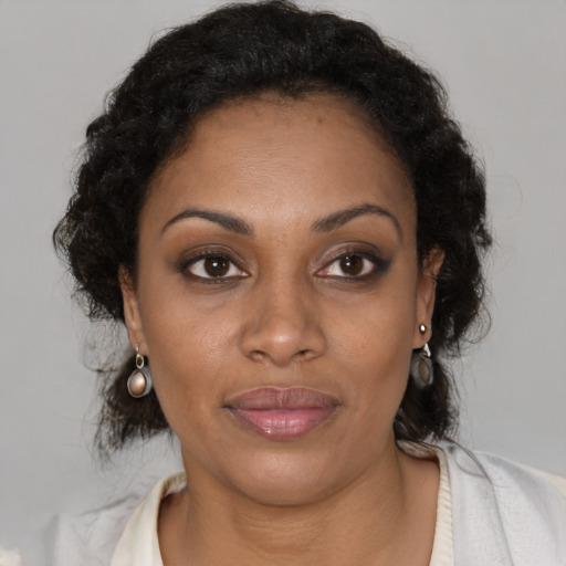 Joyful black young-adult female with medium  brown hair and brown eyes