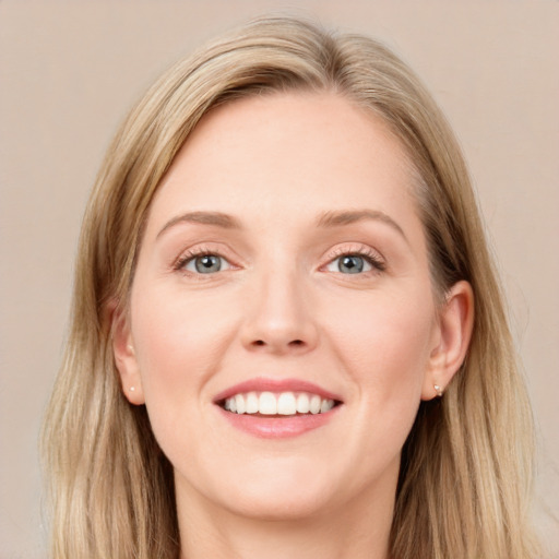 Joyful white young-adult female with long  brown hair and blue eyes