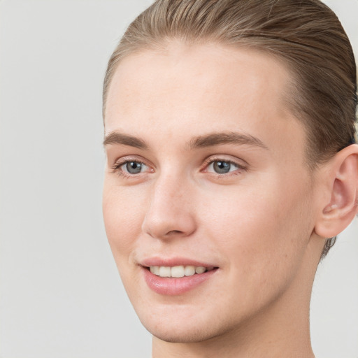 Joyful white young-adult female with short  brown hair and grey eyes