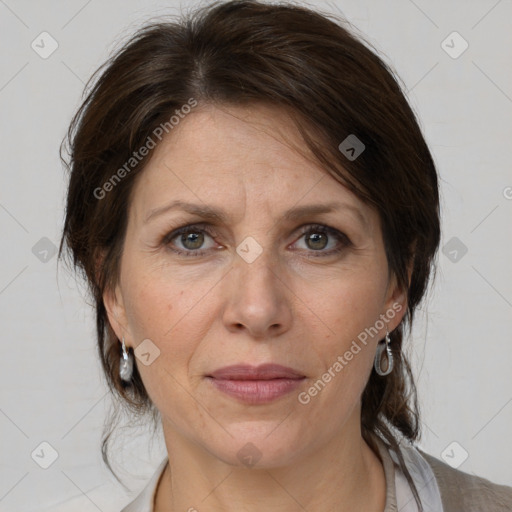 Joyful white adult female with medium  brown hair and grey eyes