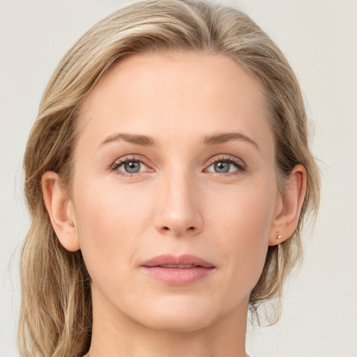 Joyful white young-adult female with medium  brown hair and blue eyes