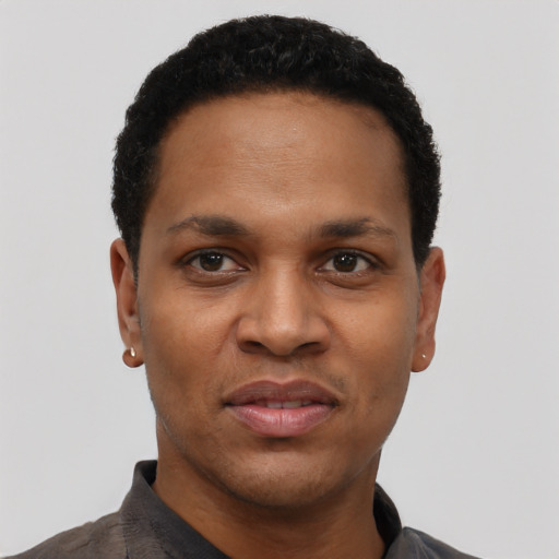 Joyful black young-adult male with short  black hair and brown eyes