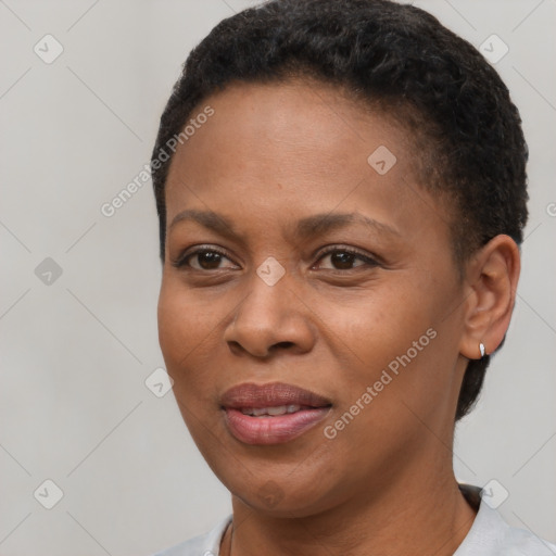 Joyful black young-adult female with short  brown hair and brown eyes