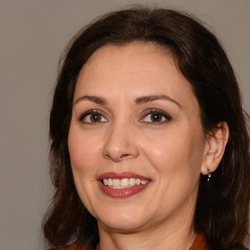 Joyful white adult female with medium  brown hair and brown eyes