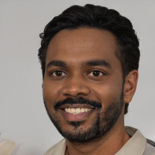 Joyful black young-adult male with short  black hair and brown eyes