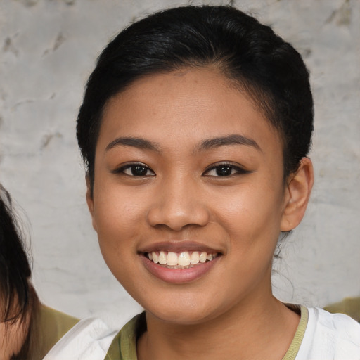 Joyful asian young-adult female with short  brown hair and brown eyes