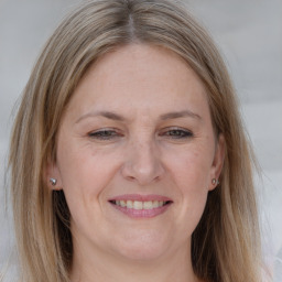 Joyful white adult female with long  brown hair and grey eyes