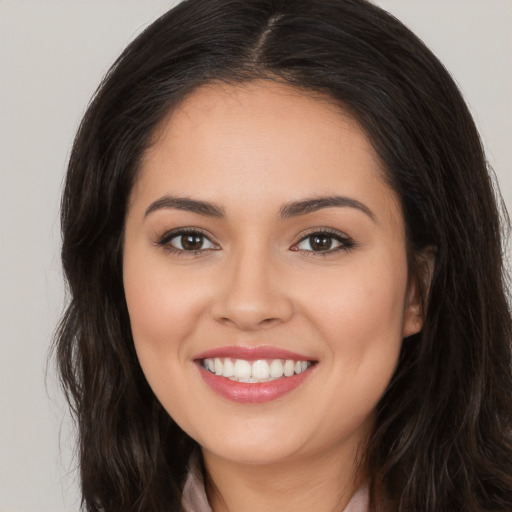 Joyful white young-adult female with long  brown hair and brown eyes