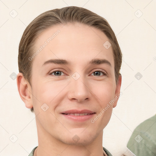 Joyful white young-adult male with short  brown hair and grey eyes