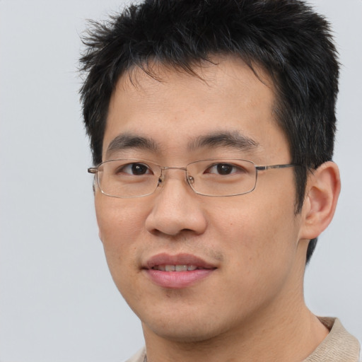 Joyful asian young-adult male with short  brown hair and brown eyes