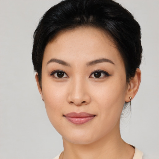 Joyful asian young-adult female with short  black hair and brown eyes