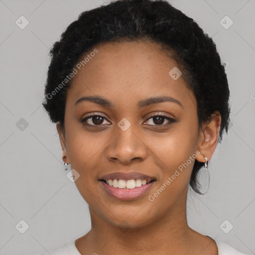 Joyful black young-adult female with short  black hair and brown eyes