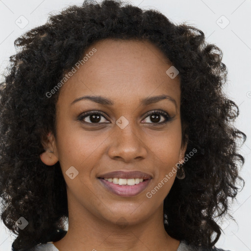 Joyful black young-adult female with long  brown hair and brown eyes